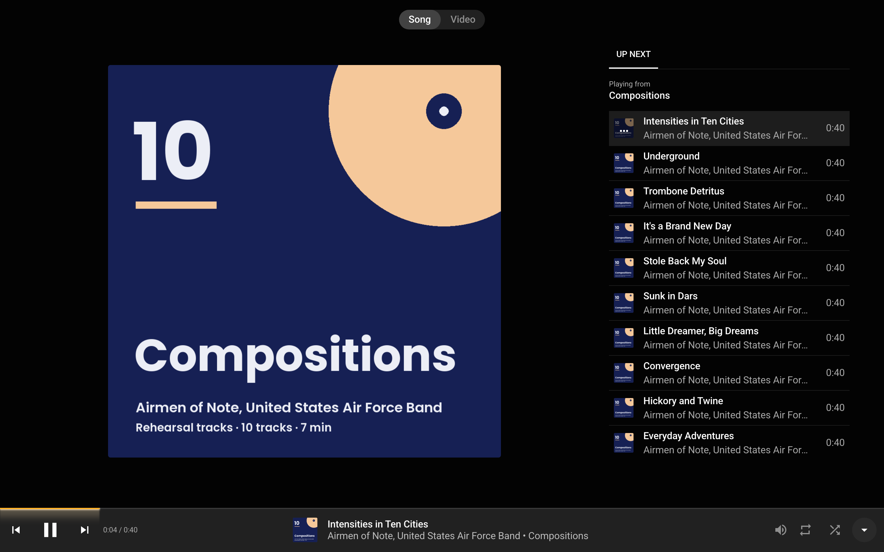Now Playing on a wide screen: the Song and Video switch at the top, the cover on the left, the Up next list on the right, and the player bar along the bottom